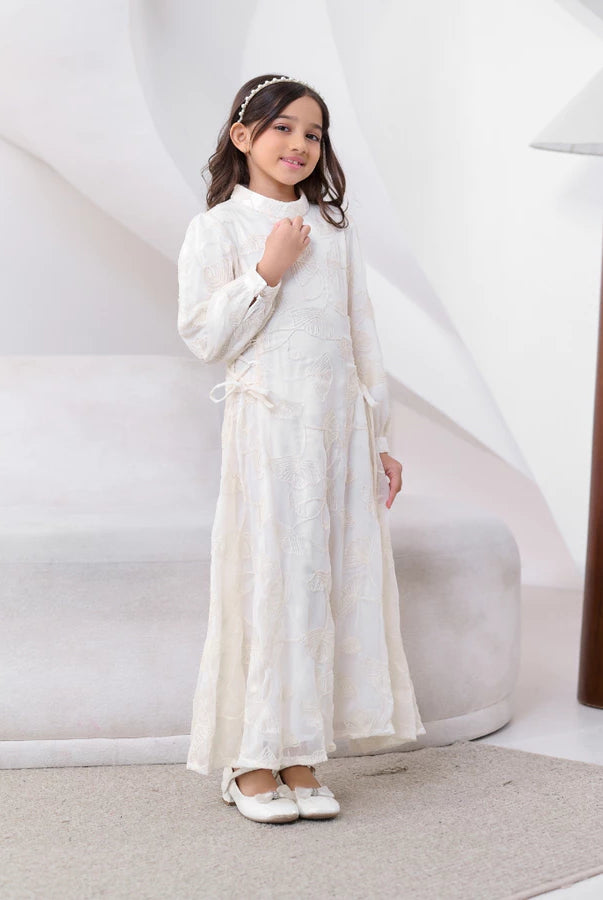 Young girl in a white dress by Kasa Heritage standing against a white background