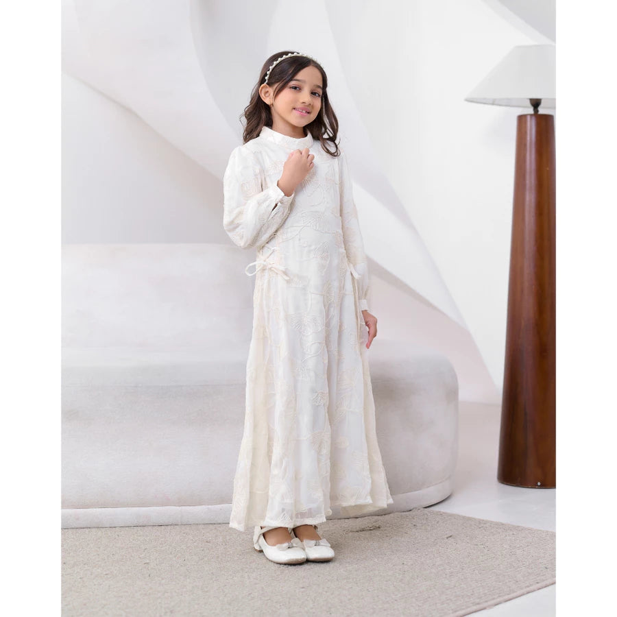Young girl in a white dress by Kasa Heritage standing against a white background