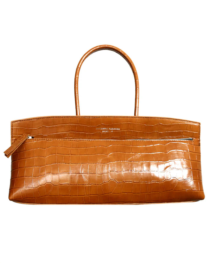 Brown alligator embossed leather baguette bag with a zip closure and tubular handles by Aesthetic Pleasure.