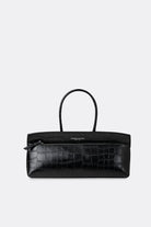 Black baguette handbag with crocodile texture by Aesthetic Pleasure on a white background
