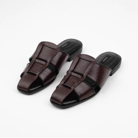 Pair of brown mules sandal by Cekhas on a white background