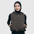 Woman wearing a brown sleeveless vest with a hood by HIA on a white background