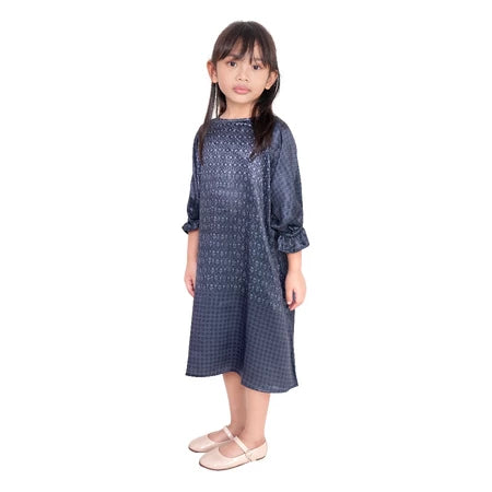 A navy blue girl's tunic with a crinkle silk material, displayed on a young model.
