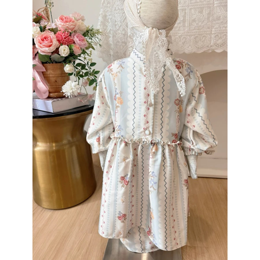 Floral outfit set by Haidee Orlin with blue accents on a mannequin with a decorative background