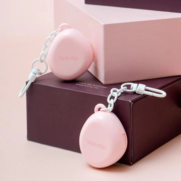 Pink Amber Dream Solid Perfume bottle by Hijabchic with a keychain on a pink and brown box