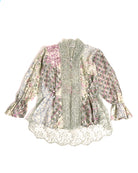 A traditional kebaya blouse by Kartinis Label featuring long sleeves, batik pattern, and beaded lace detailing with a multicolor palette.