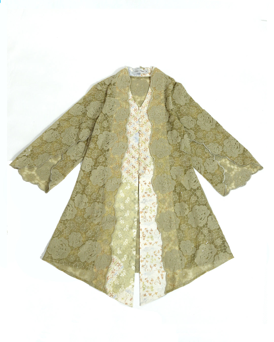 A beige and gold floral embroidered organza tunic by Kartinis Label with batik details, featuring a front opening with buttons and beadings, displayed on a mannequin.
