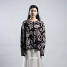 Woman wearing a dark brown floral patterned cardigan by BWBYAZ against a plain background