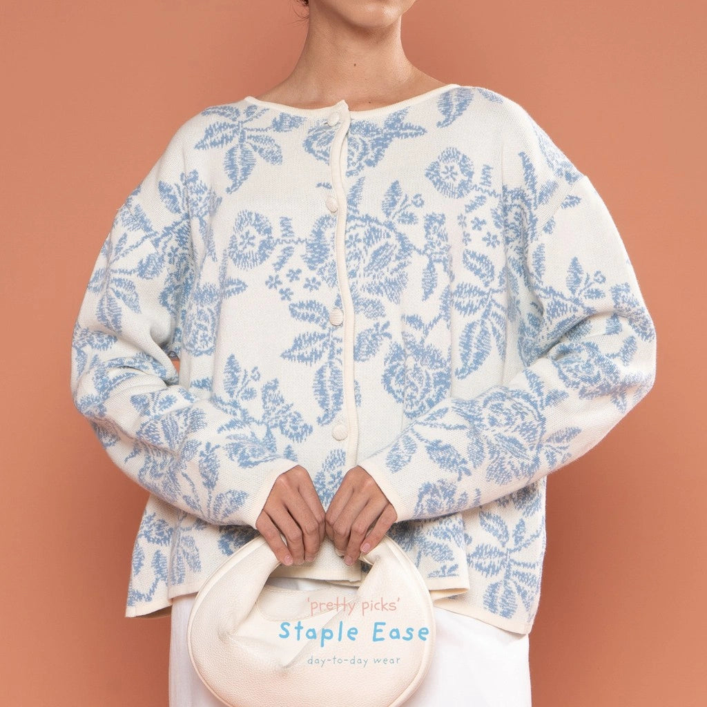 Person wearing a white cardigan by BWBYAZ with blue floral pattern against a peach background