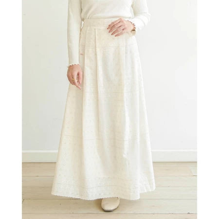 Person wearing a long white skirt by Mistyvori and white top against a light background