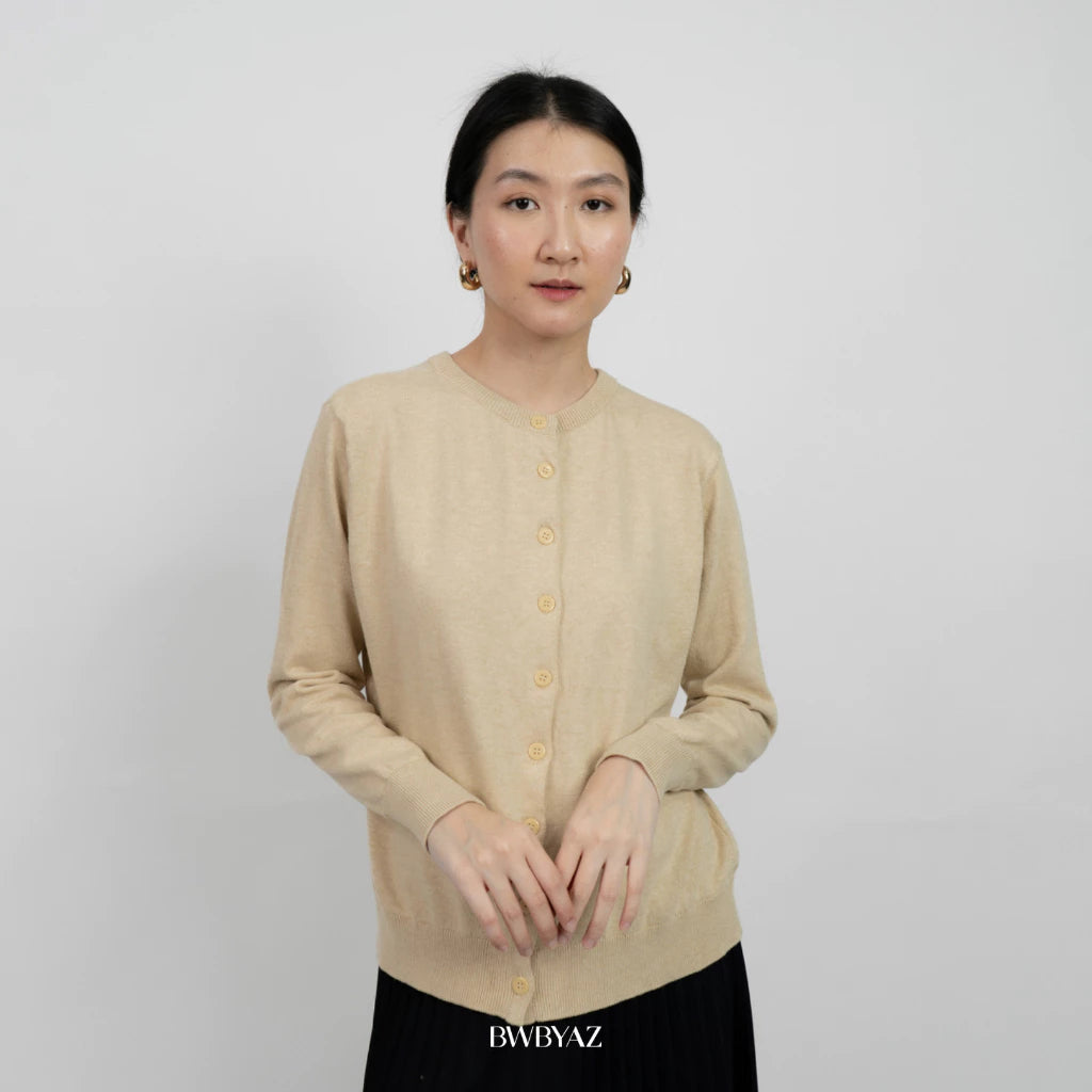 A person wearing a beige, long-sleeved, button-up cardigan with round neckline from BWBYAZ.