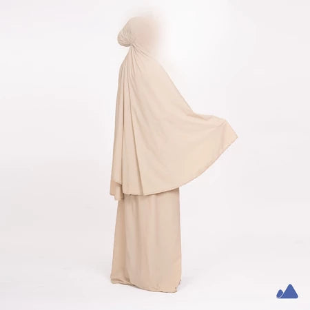 Beige prayer hijab with a draped design from Muhajir Project on a white background