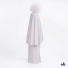 Misty grey prayer hijab with a draped design from Muhajir Project on a white background