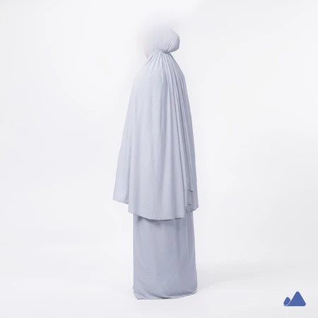Light blue prayer hijab with a draped design from Muhajir Project on a white background