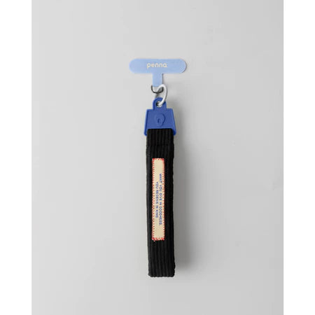 Black keychain strap strap with a blue clip from Muhajir Project on a gray background