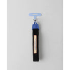 Black keychain strap strap with a blue clip from Muhajir Project on a gray background