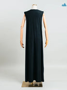 Rear view of black sleeveless dress from Muhajir Projecton a mannequin against a white background