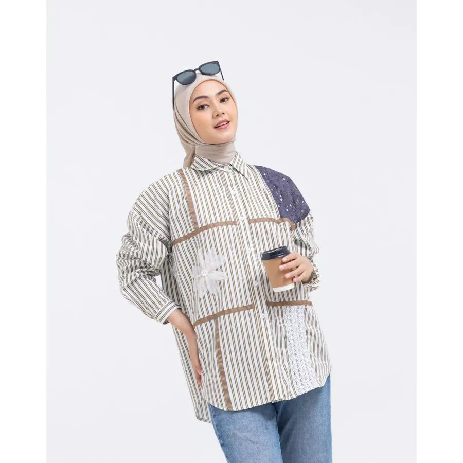 Woman wearing a striped shirt by Abame with brown line accents, holding a coffee cup on a white background