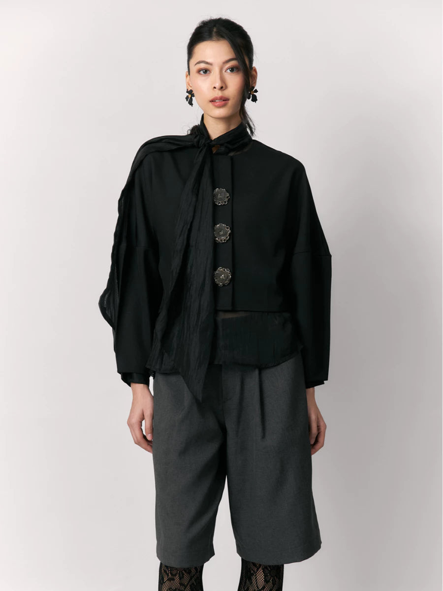 Person wearing a black shirt by Studio Tui with a white background