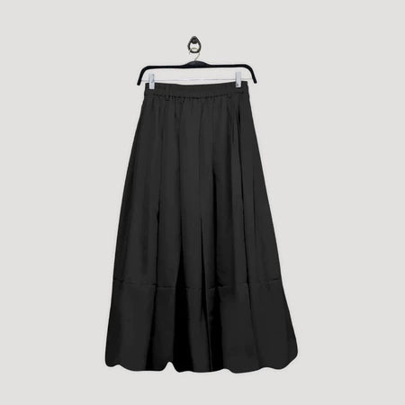 Black skirt by Maima on a hanger against a light gray background