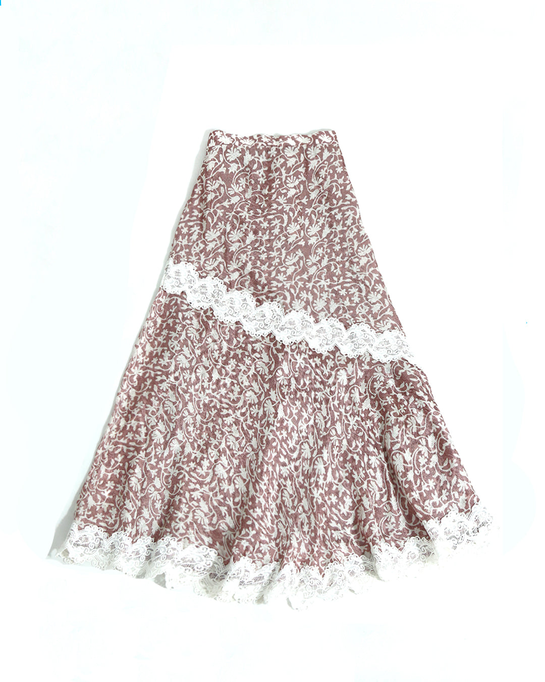 Long asymmetric skirt by Kartinis Label with mermaid silhouette cut, lace details, and side opening with zipper.