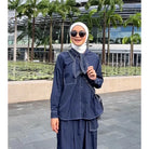 A woman standing outdoors wearing a navy shirt with long sleeves and a round neckline by Casa Elana, the shirt appears to be made of crinkle fabric.