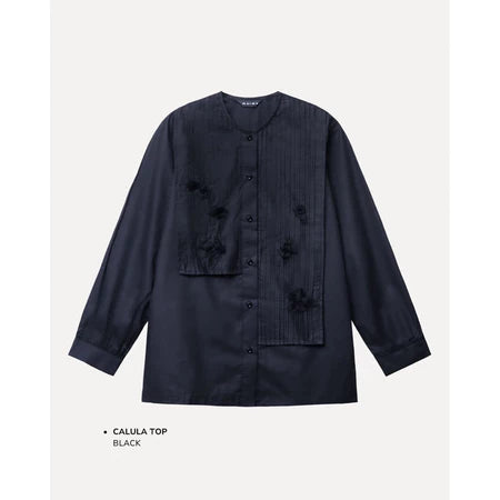 Black shirt by Maima with floral details on a light gray background