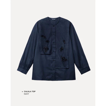 Navy blue shirt by Maima with floral embellishments on a light gray background