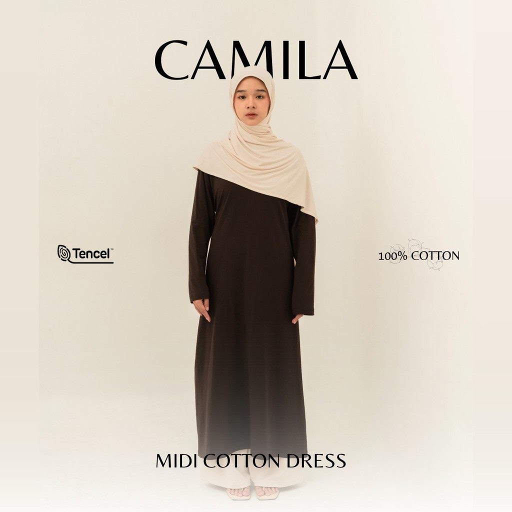 Woman wearing a dark brown maxi cotton dress by BWBYAZ with a beige hijab on a white background.