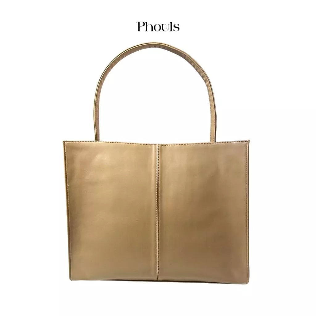 A gold-colored, synthetic leather shoulder bag with top handle and magnetic closure from Phouls.