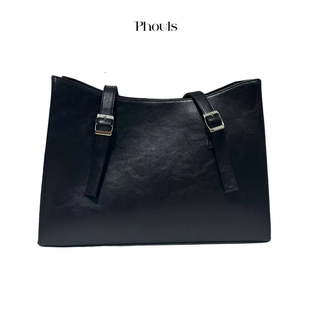 A black Cerena shoulder bag with double handles and a debossed logo of Phouls, displayed against a white background.
