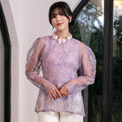 Woman wearing a light purple sheer floral outer by Holy Peony indoors.