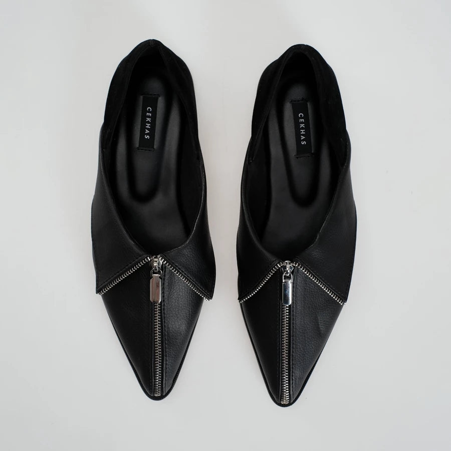 A pair of black leather pointed-toe flats shoes with a silver zipper detail running up the center front, shown from a top-down view on a light gray background. The brand name 'Cekhas' is visible on the insole.
