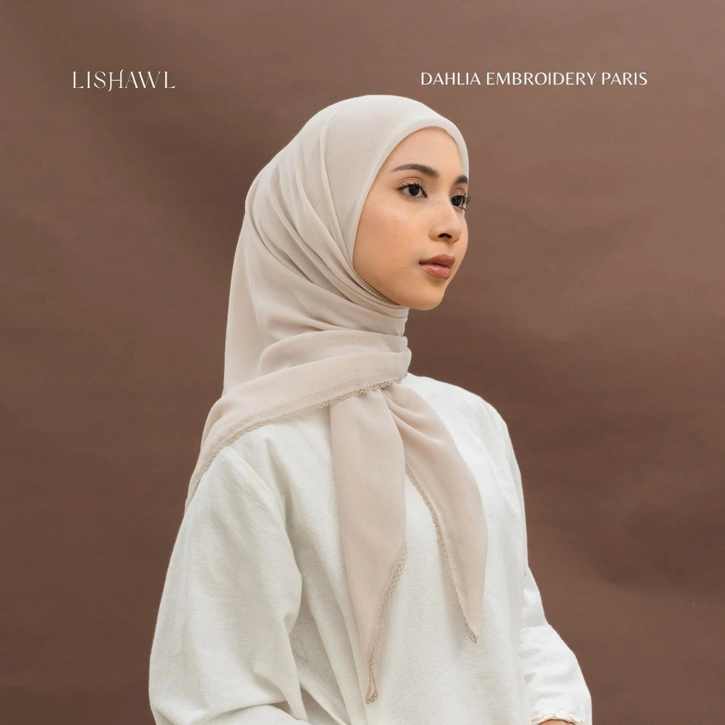 Woman wearing a beige hijab with by BWBYAZ on a brown background