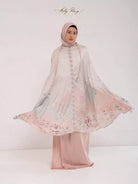 Woman wearing a floral prayer set by Holypeony with a peach-colored accents on a white background