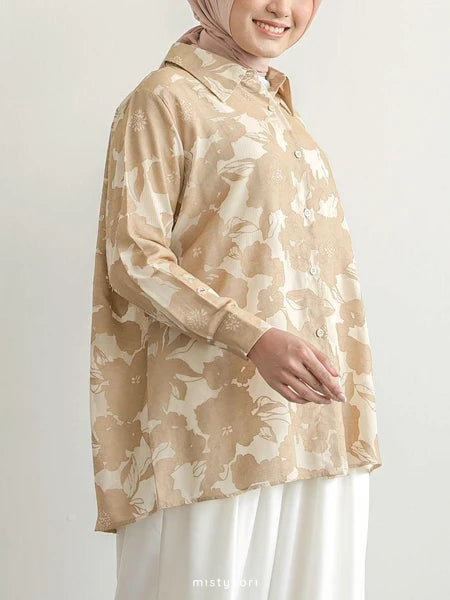 Person wearing a beige floral shirt by Mistyvori with a plain background