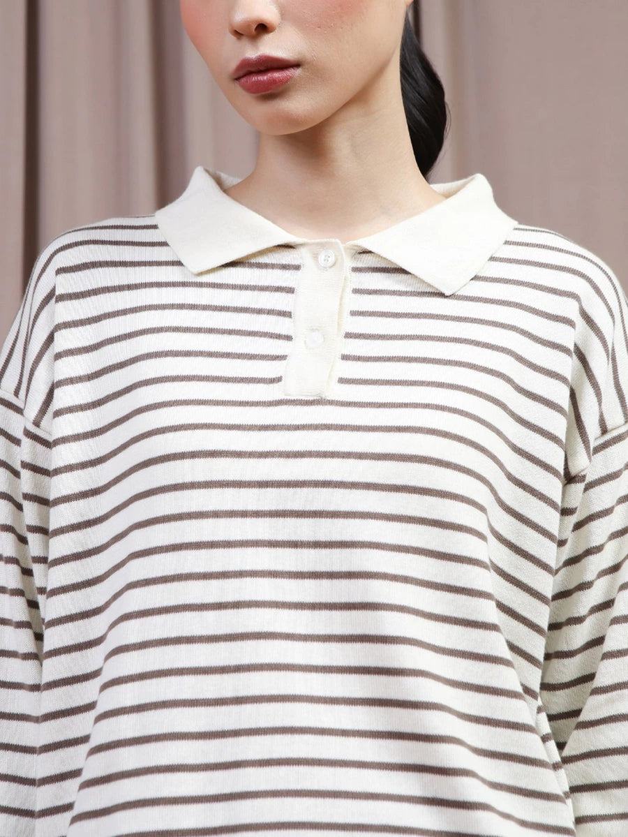 A close-up of a model wearing a long-sleeve polo shirt by Hijabchic with thin brown horizontal stripes on an off-white base, featuring an off-white collar and a three-button placket.