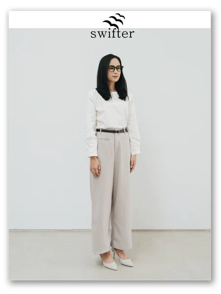 Person wearing a white shirt and grey pants by Swifter