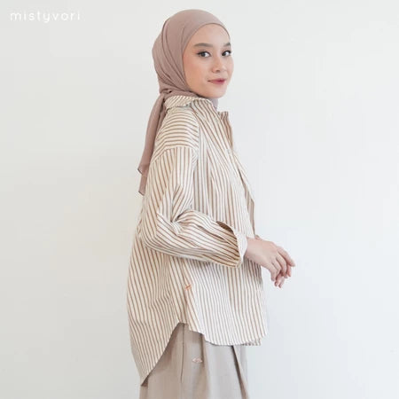 Woman wearing a cream striped shirt by Mistyvori and hijab on a white background