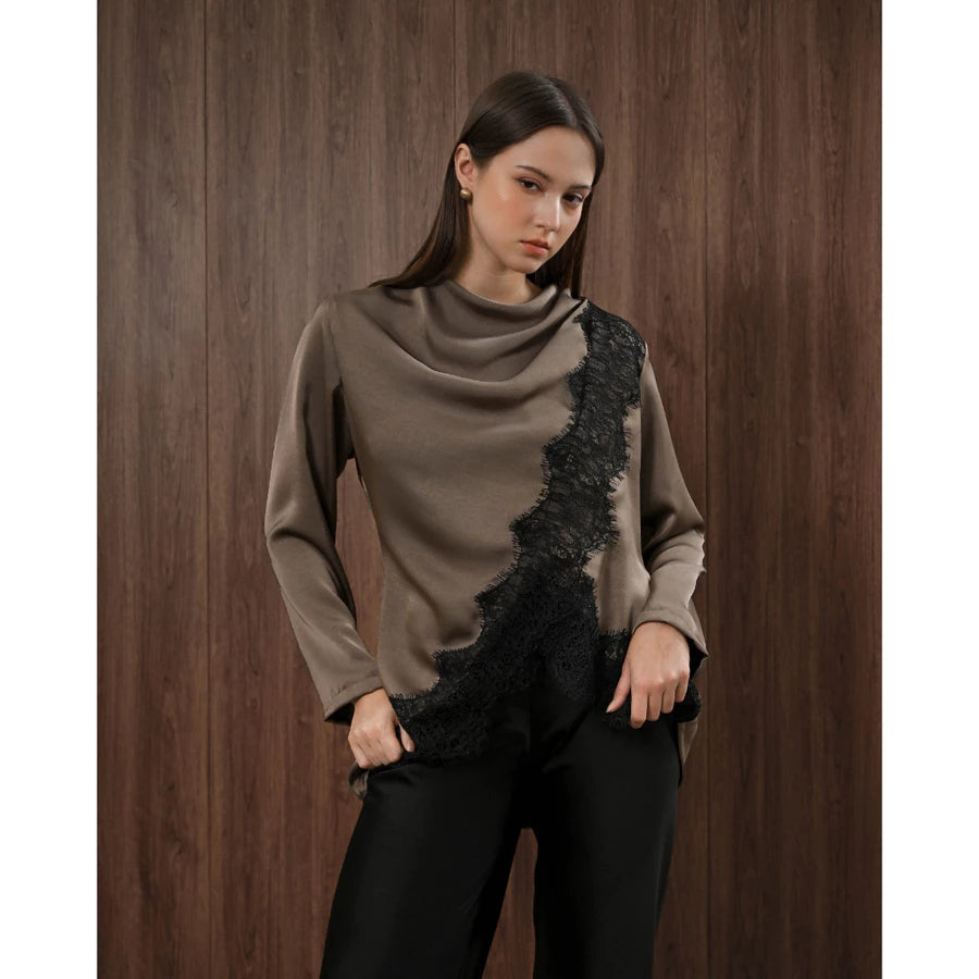 Woman wearing a brown blouse with black lace details by Kasa Heritage against a wooden background