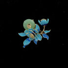 Jade brooch by Holypeony with blue floral design on a black background