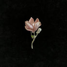 Pink lotus-shaped brooch by Holypeony on a black background