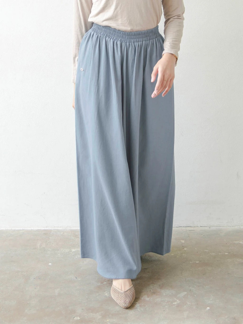Person wearing light denim blue wide-leg pants by Mistyvori on a plain background