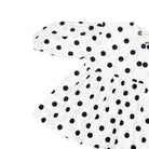 White dress with black polka dots by Yestoday on a white background