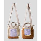 Women’s reversible tote bag by Muhajir Project featuring two looks in one design. One side comes in beige with brown accents and a lilac front pocket, while the other side shows a brown body with a contrasting lilac pocket. Designed with adjustable shoulder straps, top handles, and side drawstring details for a practical and versatile everyday bag.