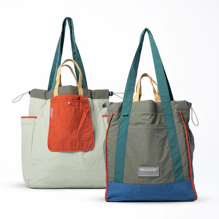 Reversible tote bag with different color combinations from Muhajir Project on a white background
