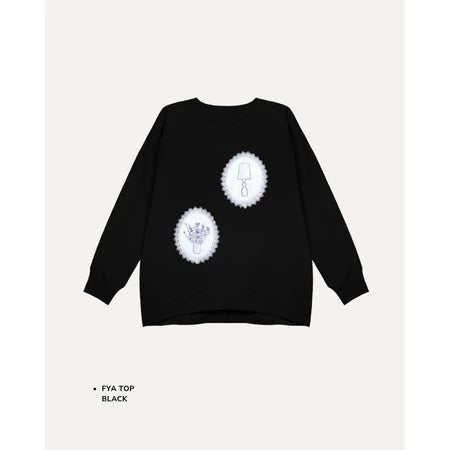 Black t-shirt by Maima with white designs on a light gray background