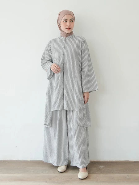 Woman wearing a gray striped outfit set by Mistyvori with a hijab against a white background