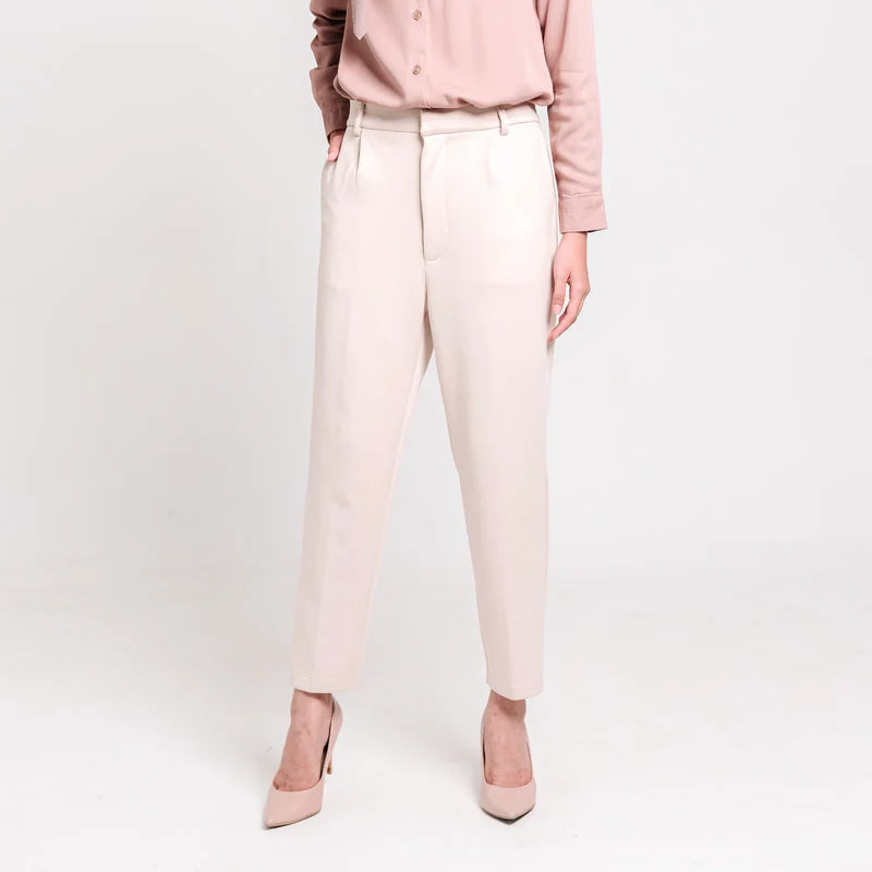 Person wearing ivory ankle pants from Atala Scarves and matching shoes on a white background