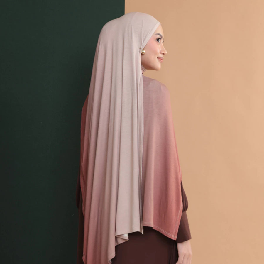 Woman wearing a hijab shawl with a gradient effect by Lozy Hijab on a two-tone background